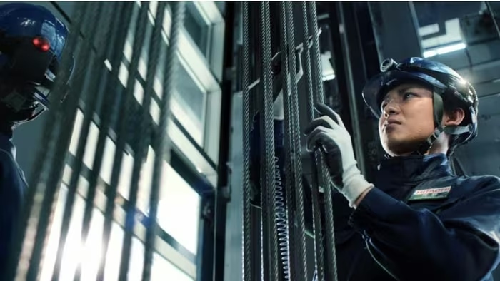 A Hitachi Building Systems technician inspects an elevator. Photo: Nikkei Asia